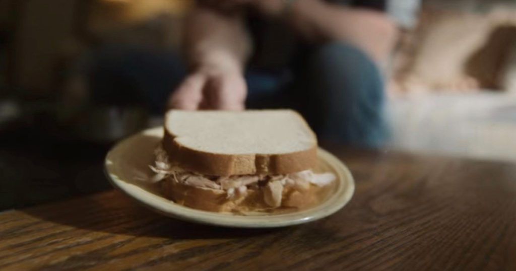 Monster: The Jeffrey Dahmer Story - Dahmer hands meat sandwich to Glenda Cleveland