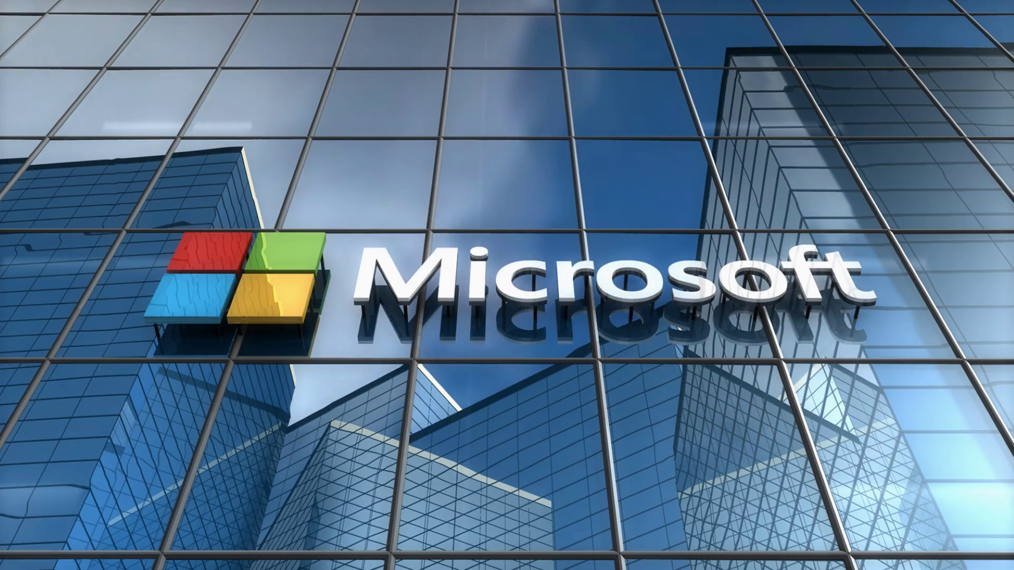 A Picture Of The Microsoft Logo On A Glass Building 