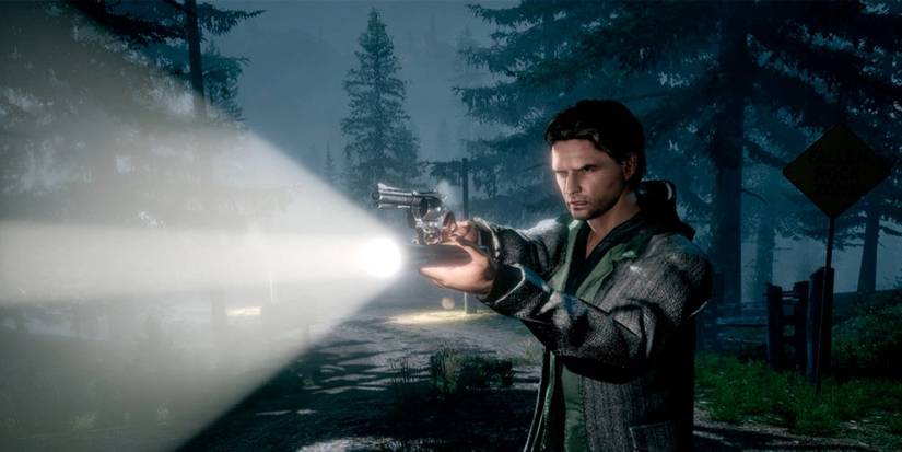 alan wake holding a flashlight and gun