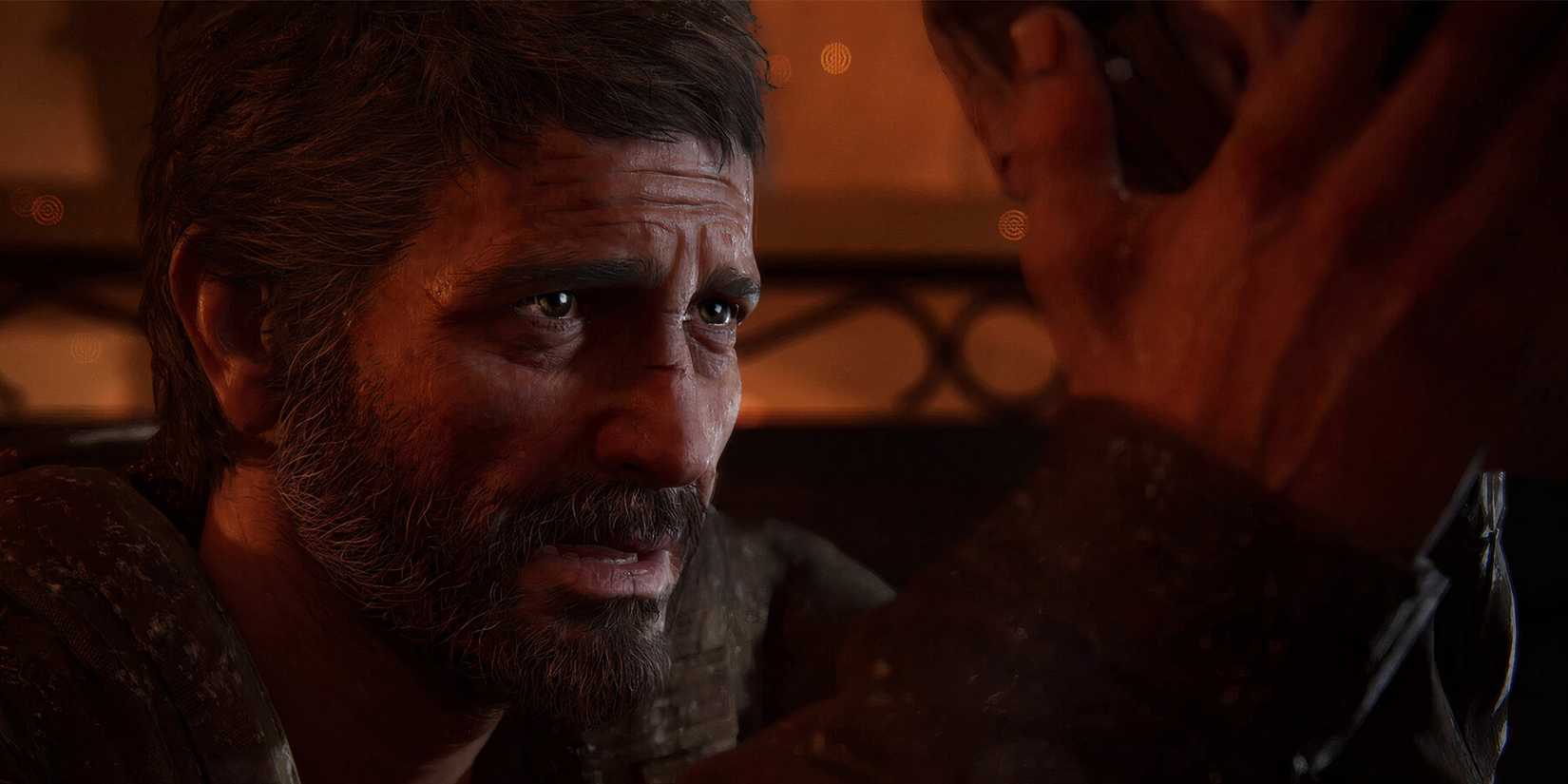 Joel Miller from The Last of Us Part I holds Ellie's face