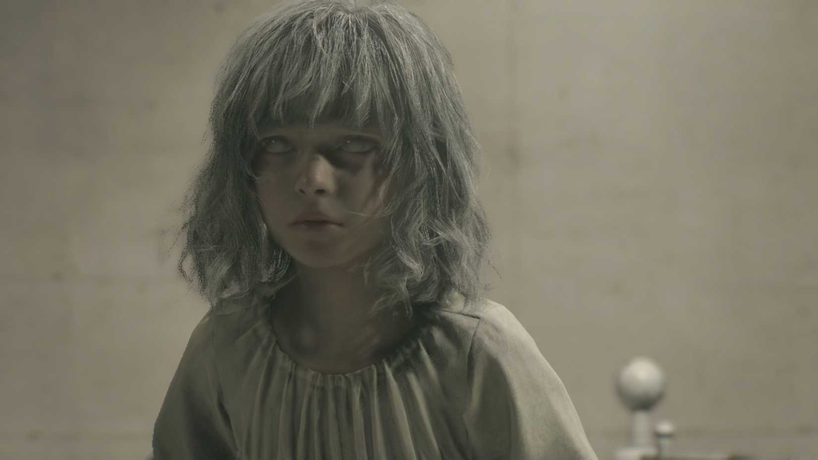 Emily sitting on her bed.